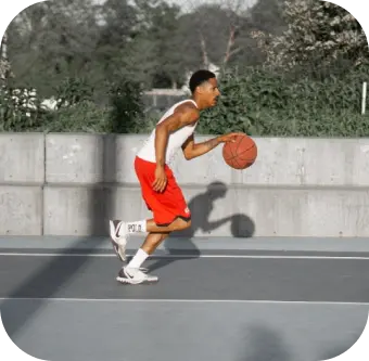 Player playing a basketball at sports academy event